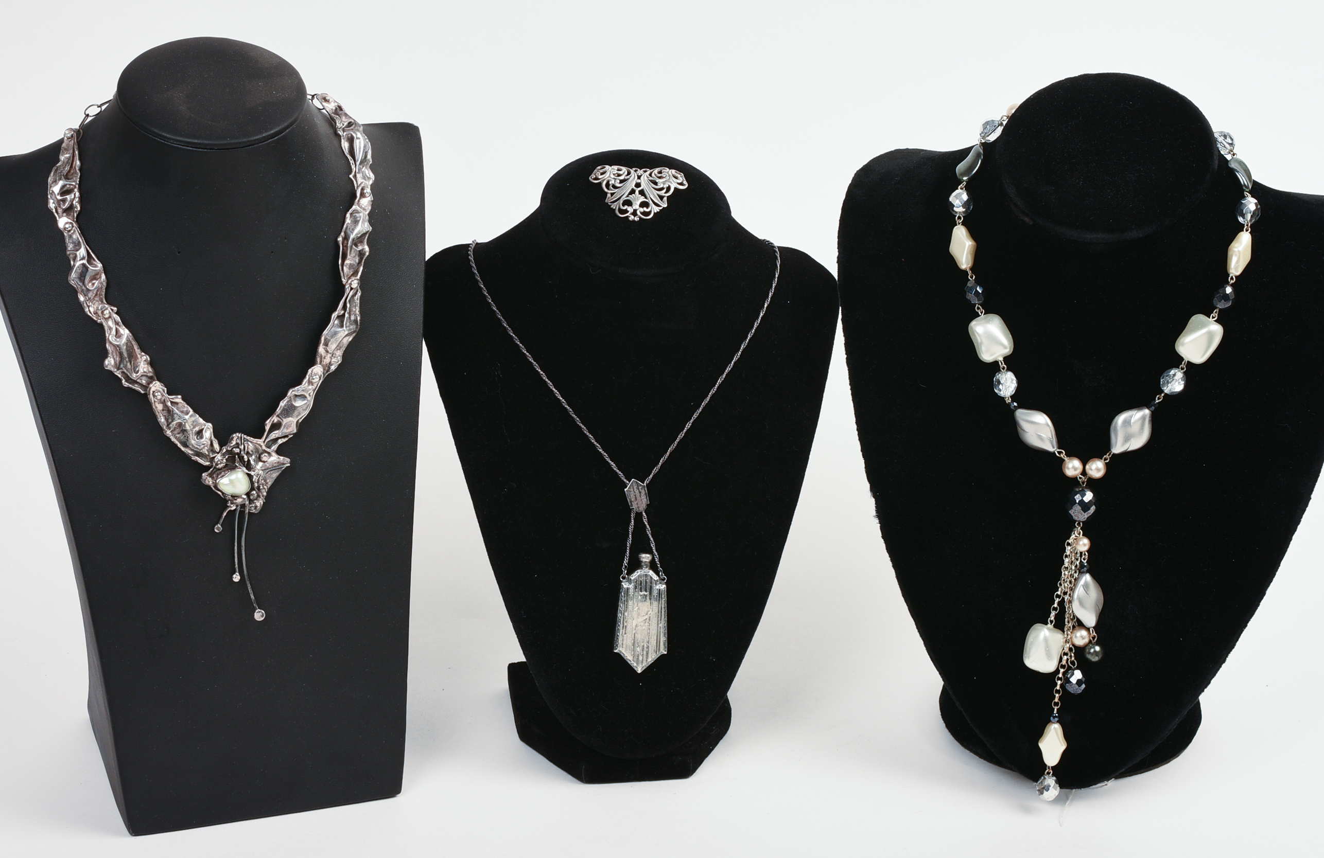 THREE NECKLACES AND A BROOCH.