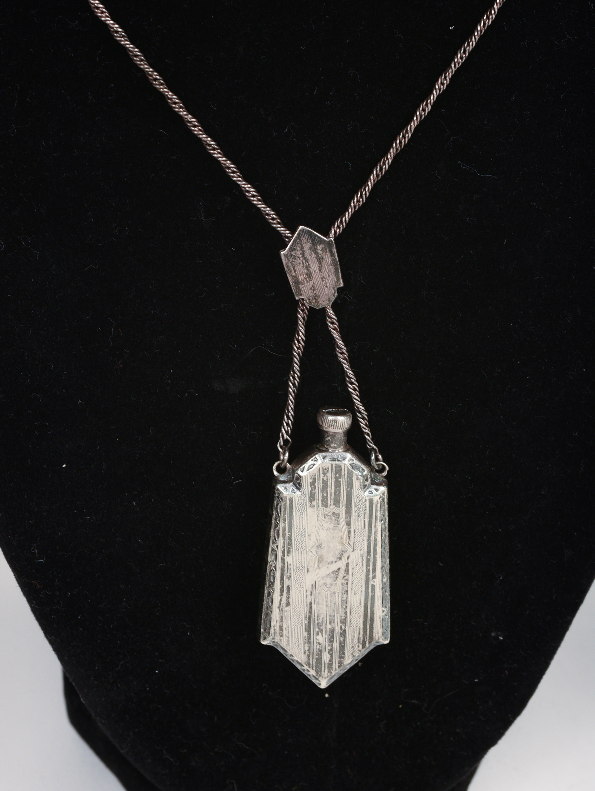 THREE NECKLACES AND A BROOCH.