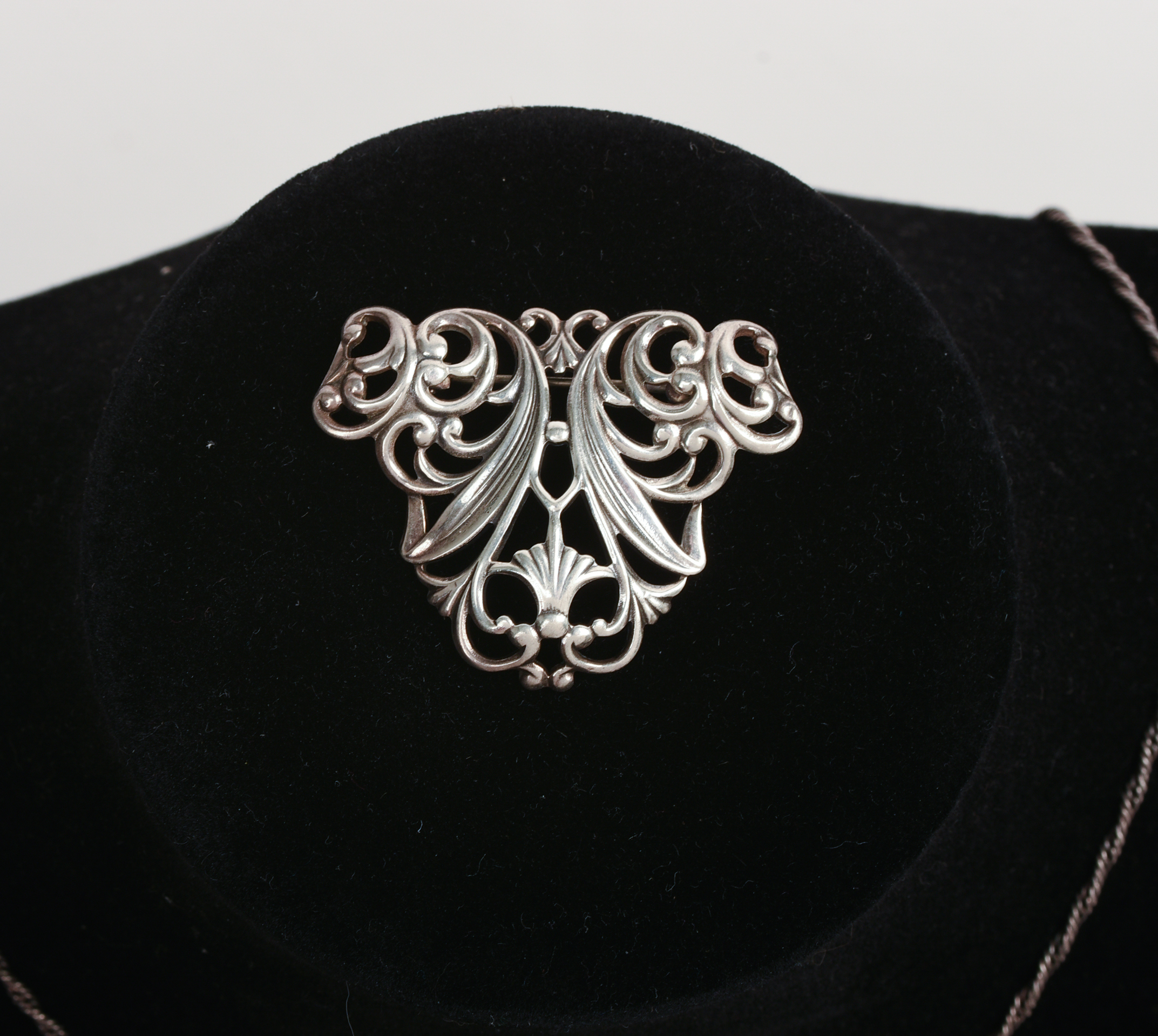 THREE NECKLACES AND A BROOCH.