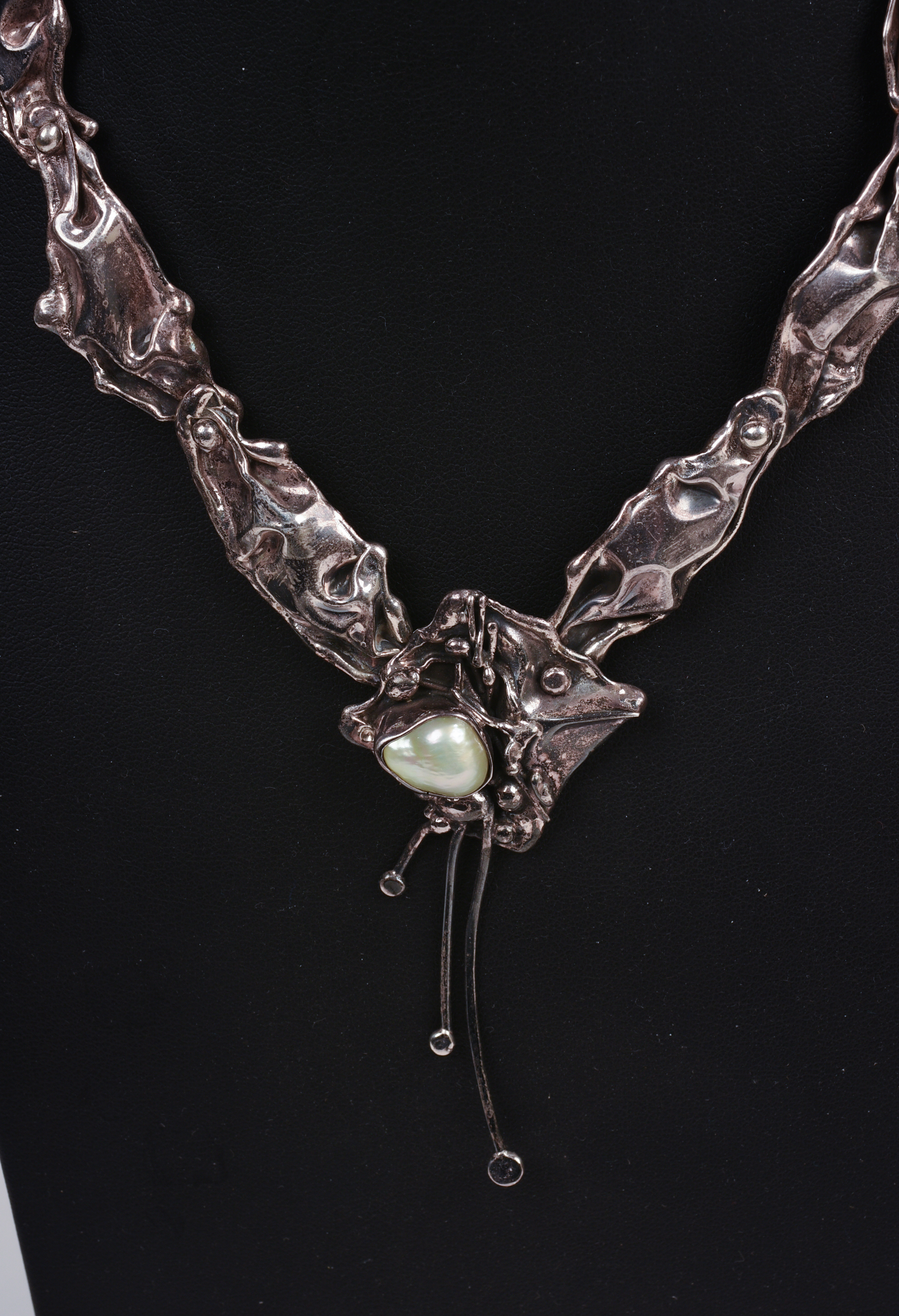 THREE NECKLACES AND A BROOCH.