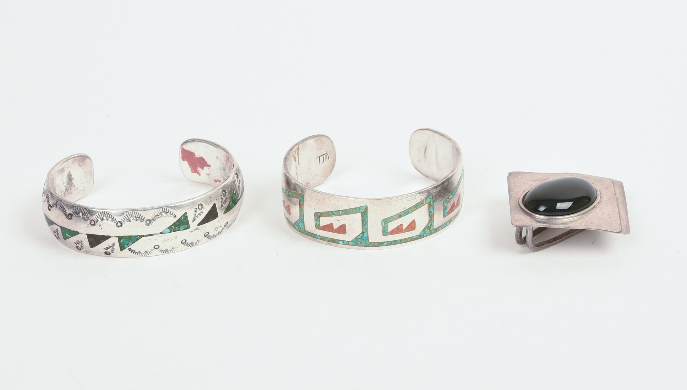 TWO NAVAJO CUFF BRACELETS AND A PENDANT.