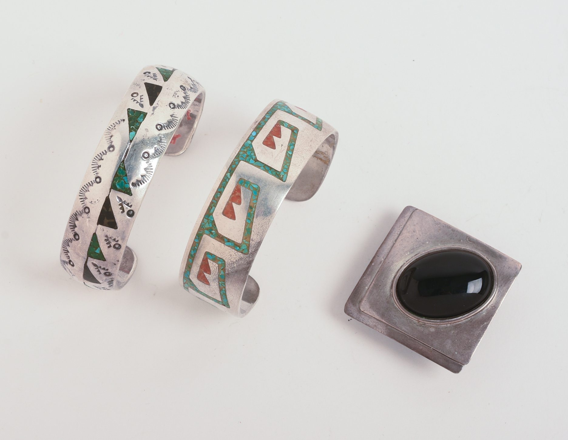 TWO NAVAJO CUFF BRACELETS AND A PENDANT.