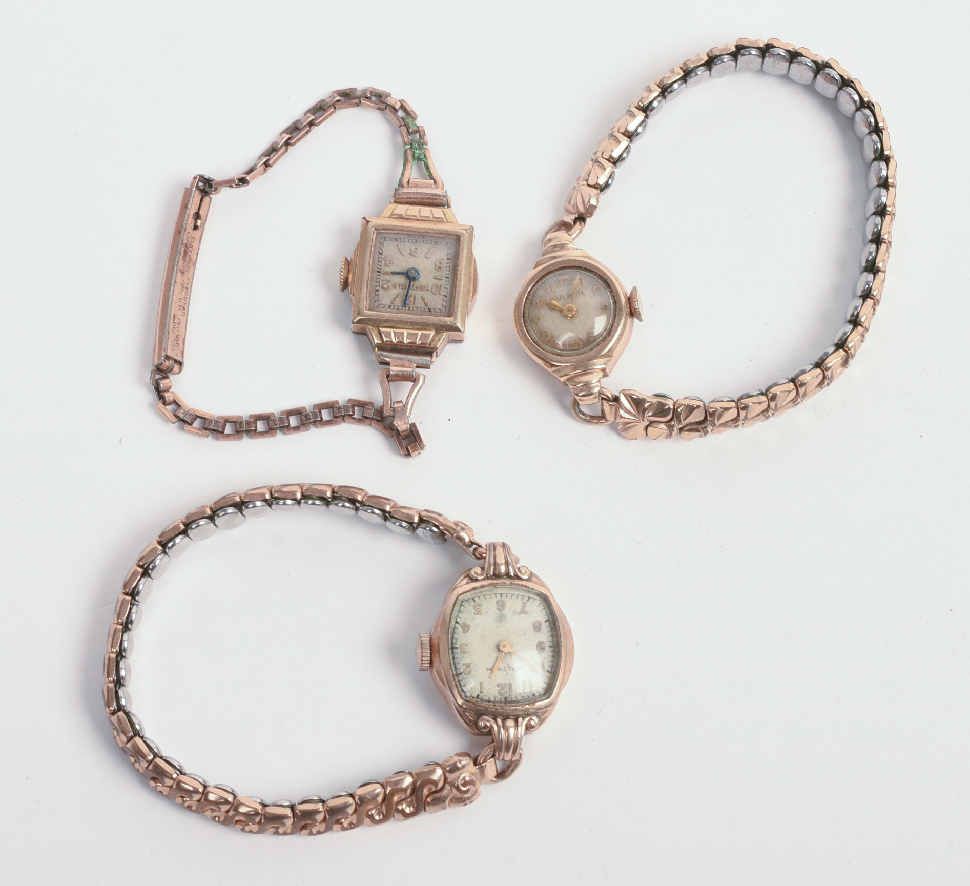 THREE ROLLED GOLD LADIES WATCHES.