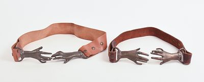 TWO BRASS AND LEATHER HAND BELTS. Length 32 inches.