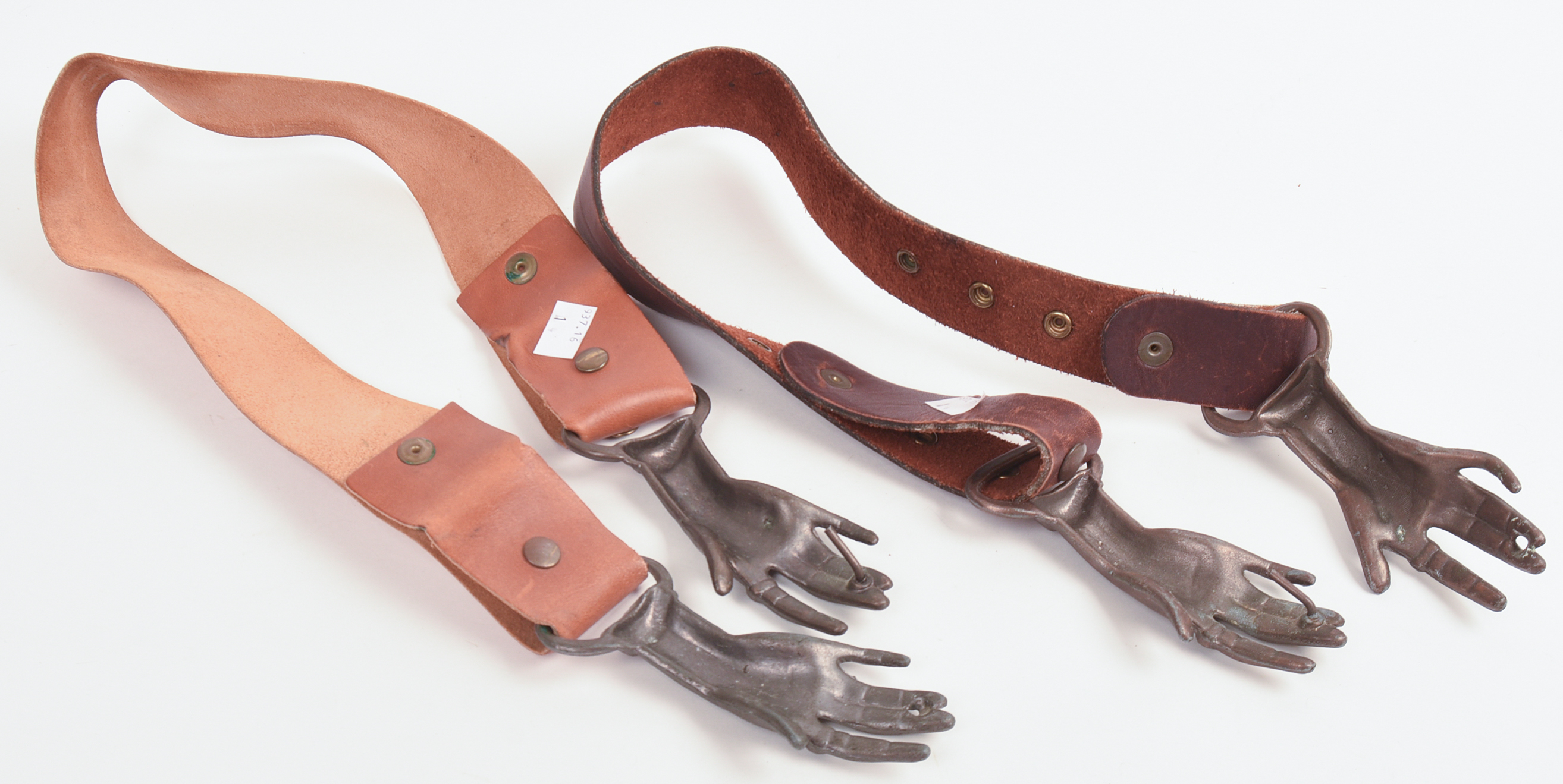 TWO BRASS AND LEATHER HAND BELTS.