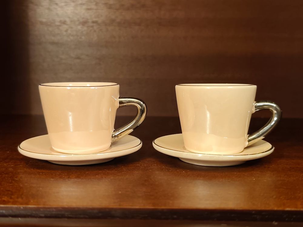 Two vintage espresso cups with saucers.