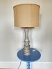 A Fangio Lighting Distressed Resin Table Lamp with Burlap Shade. 16 x 32 A Distressed Resin Image - 1