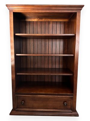 A Contemporary Stained Wood Bookcase with Drawer. A contemporary-style bookcase, constructed 