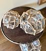 A Metal Cake Stand with Three Decorative Nautical-Style Glass Balls in Netting. This lot Image - 1