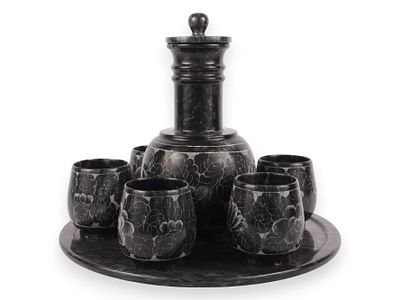 Eight-Piece Carved Black Marble Decanter Set with Etched Floral Pattern. An eight-piece carved 