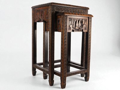 A Set of Two Chinese Carved Nesting Tables. A set of two dark brown carved wooden nesting tables 