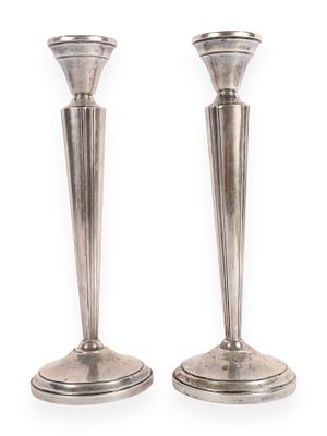 A Pair of Sterling Weighted Candlesticks. A pair of silver-colored (tarnished) candlesticks 