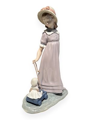 Lladro Retired 'Girl Pulling Dolls Carriage' Porcelain Figurine, Model 5044. A Lladro retired 