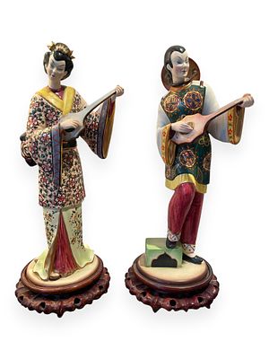 A Pair of Polychrome Glazed Porcelain East Asian Musician Figurines. This lot presents a pair of 