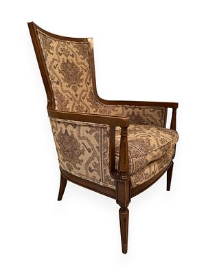 A French Louis XVI Style Armchair. A French Louis XVI style armchair featuring an exposed 