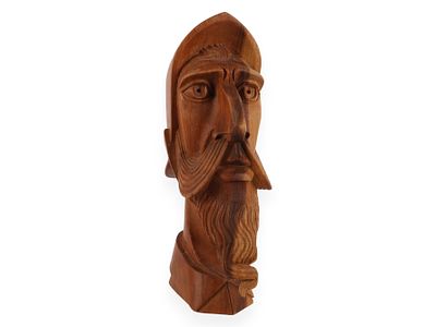 A Carved Wood Bust of Don Quixote. A carved wooden bust depicting Don Quixote, featuring a 