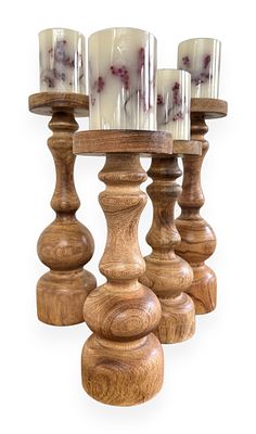 A Set of Four Graduated Wooden Candle Holders with Faux Berry Candles. A set of four graduated 