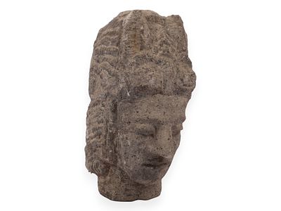 Southeast Asian Carved Volcanic Stone Head of a Deity. This carved stone sculpture depicts the 
