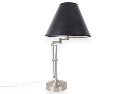 Brushed Metal Swing Arm Desk Lamp with Black Shade. A brushed metal swing-arm desk lamp 