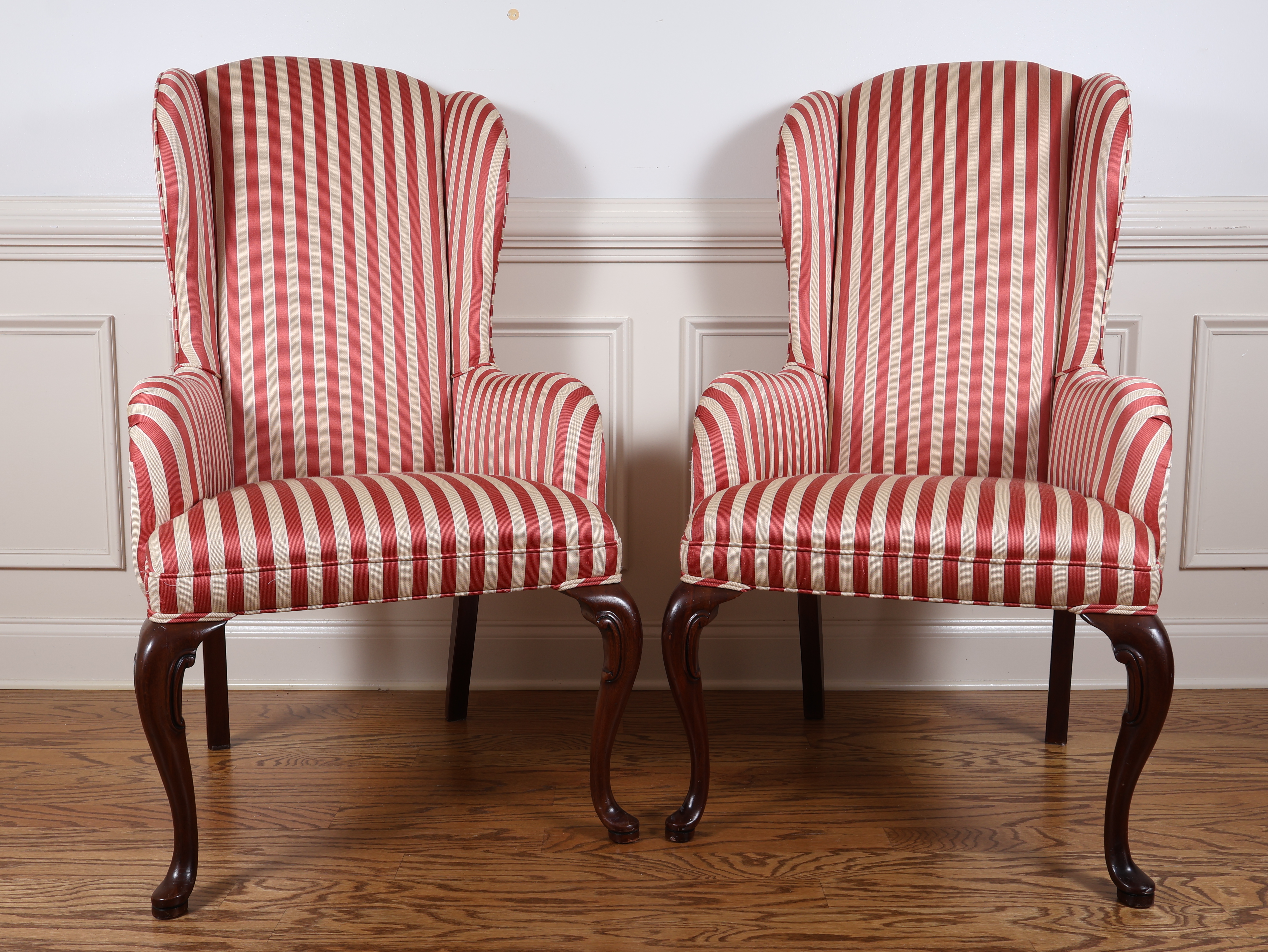 A Pair of Queen Anne Style Wingback Armchairs with Striped Upholstery