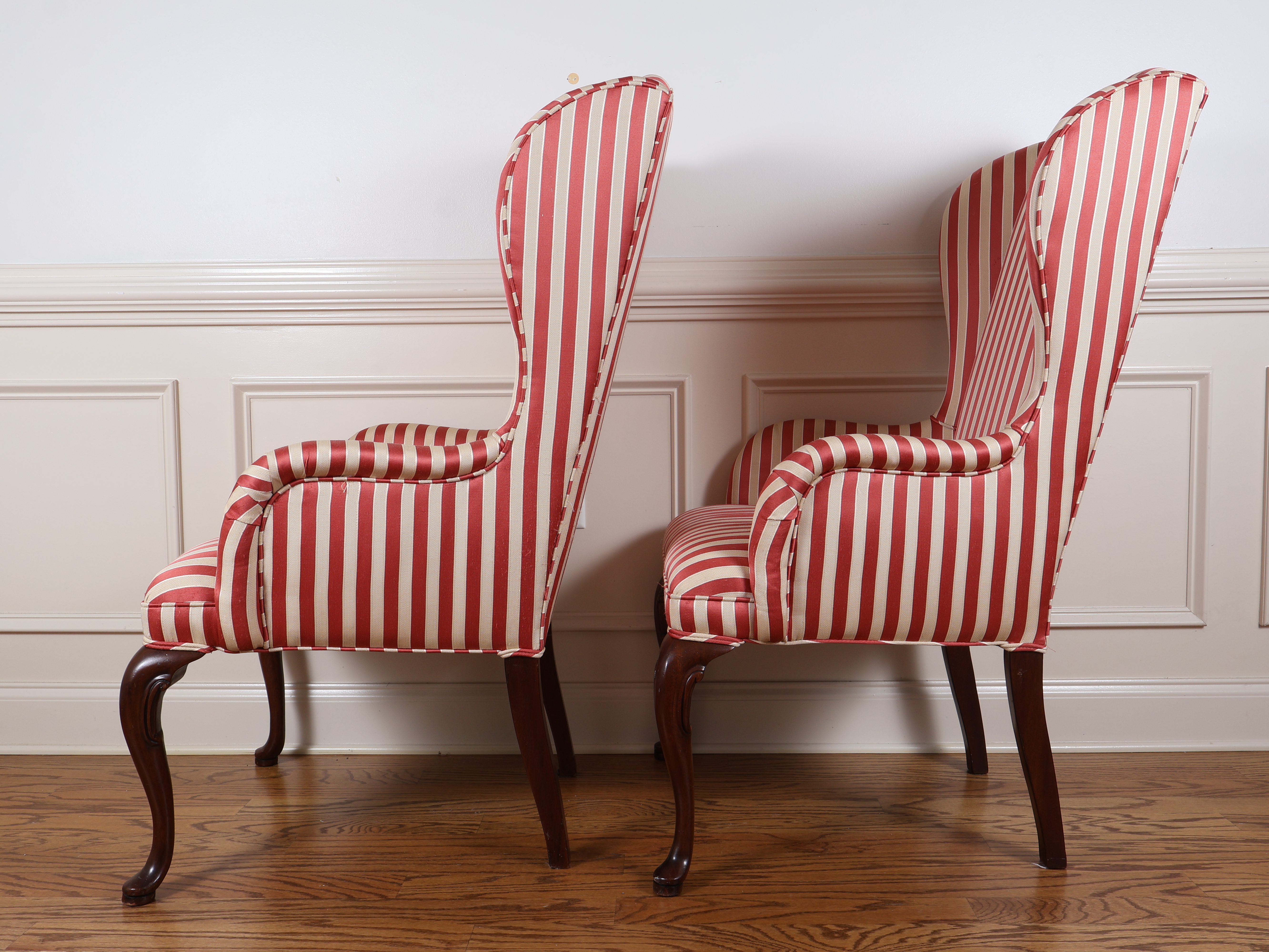 A Pair of Queen Anne Style Wingback Armchairs with Striped Upholstery
