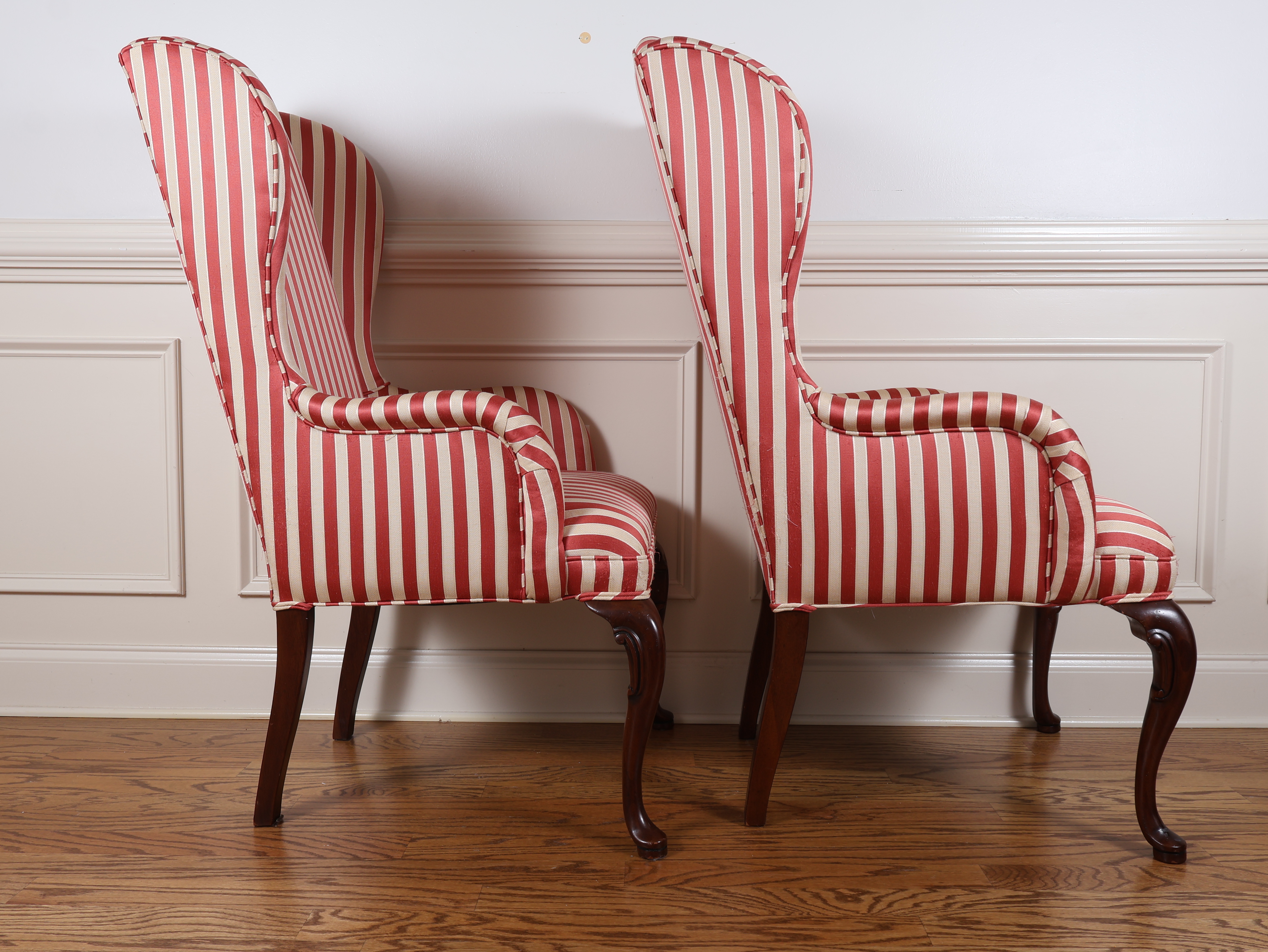 A Pair of Queen Anne Style Wingback Armchairs with Striped Upholstery