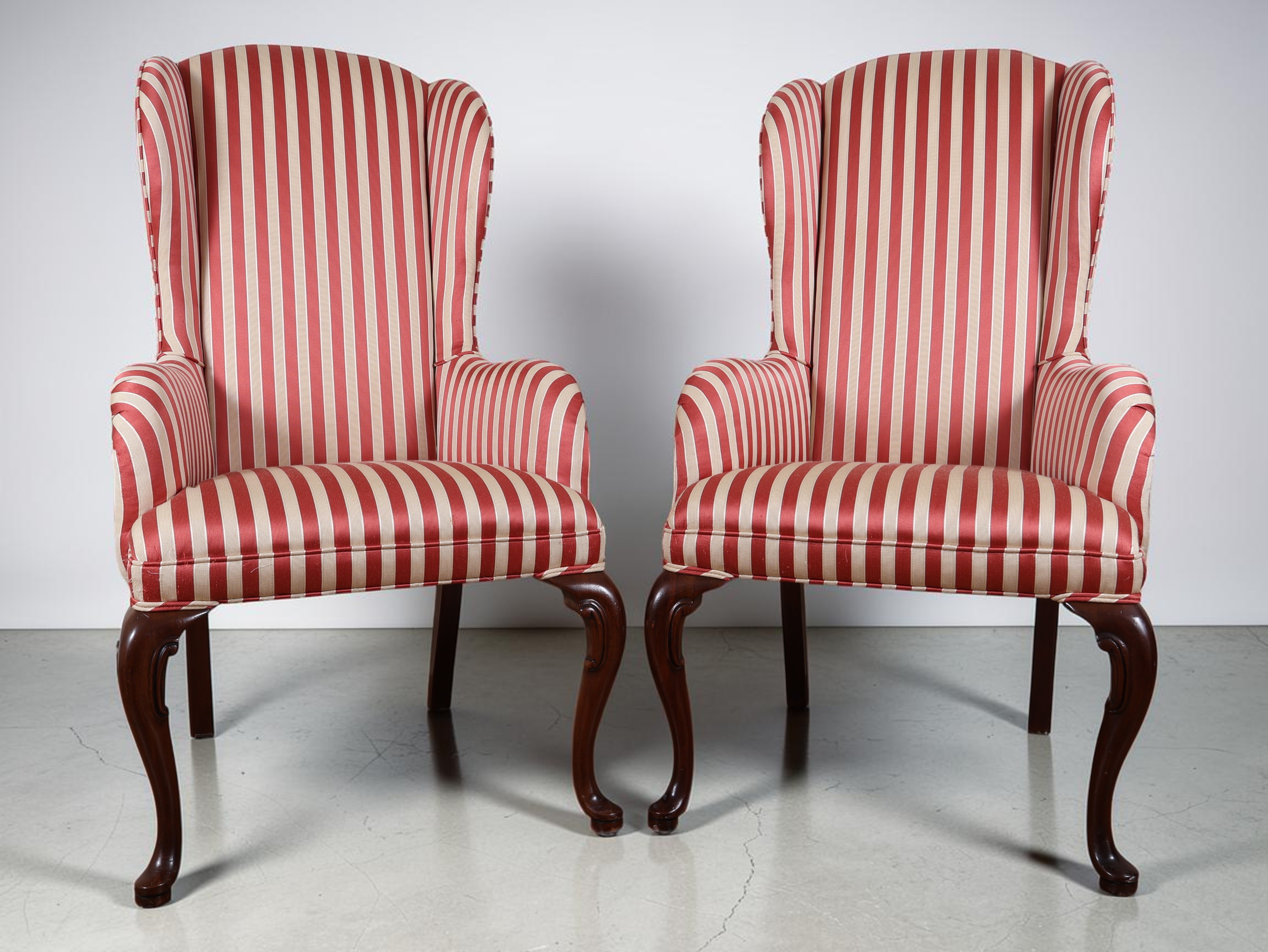 A Pair of Queen Anne Style Wingback Armchairs with Striped Upholstery