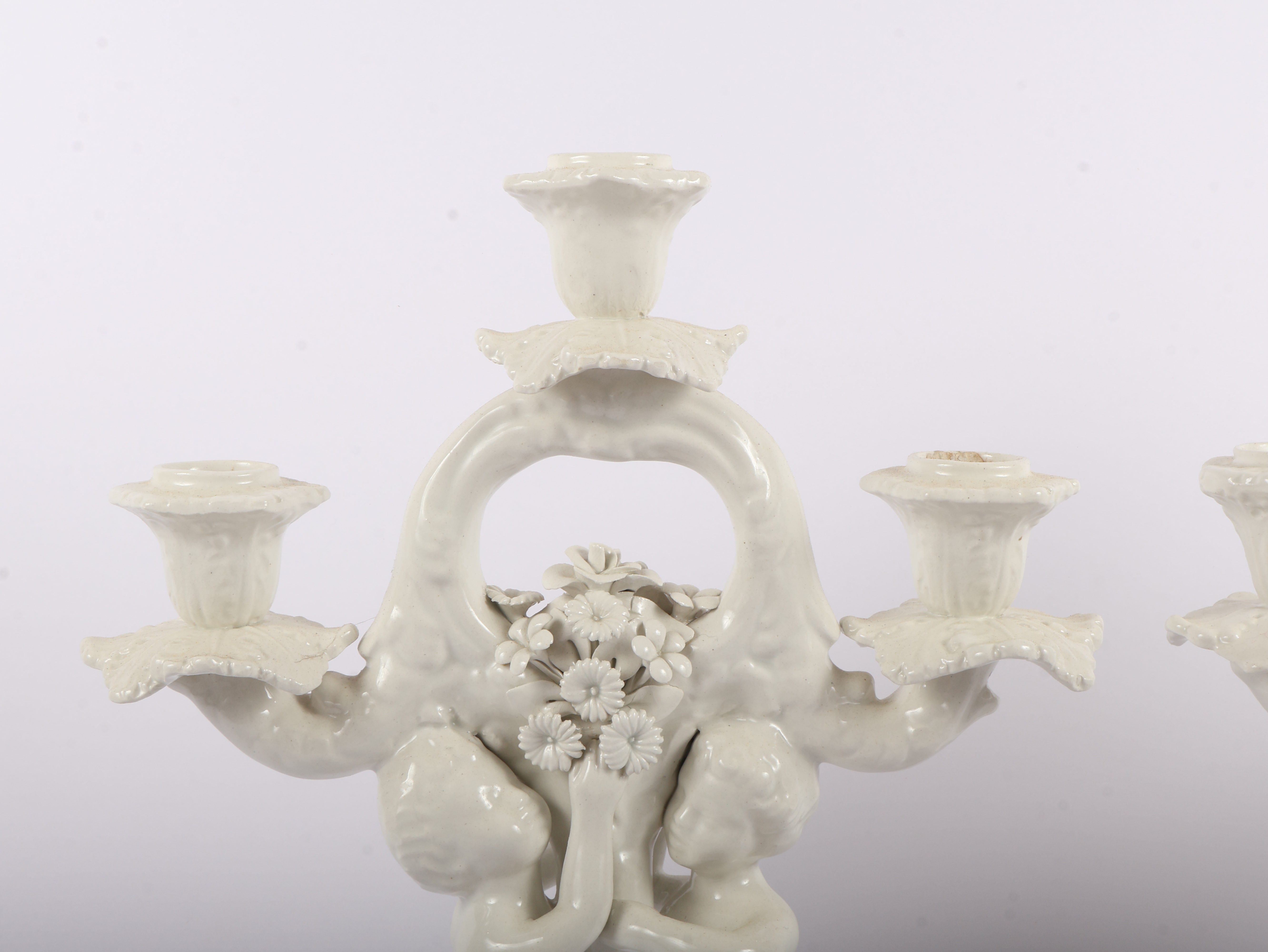 A Pair of Italian White Glazed Porcelain Three-Light Figural Candelabra