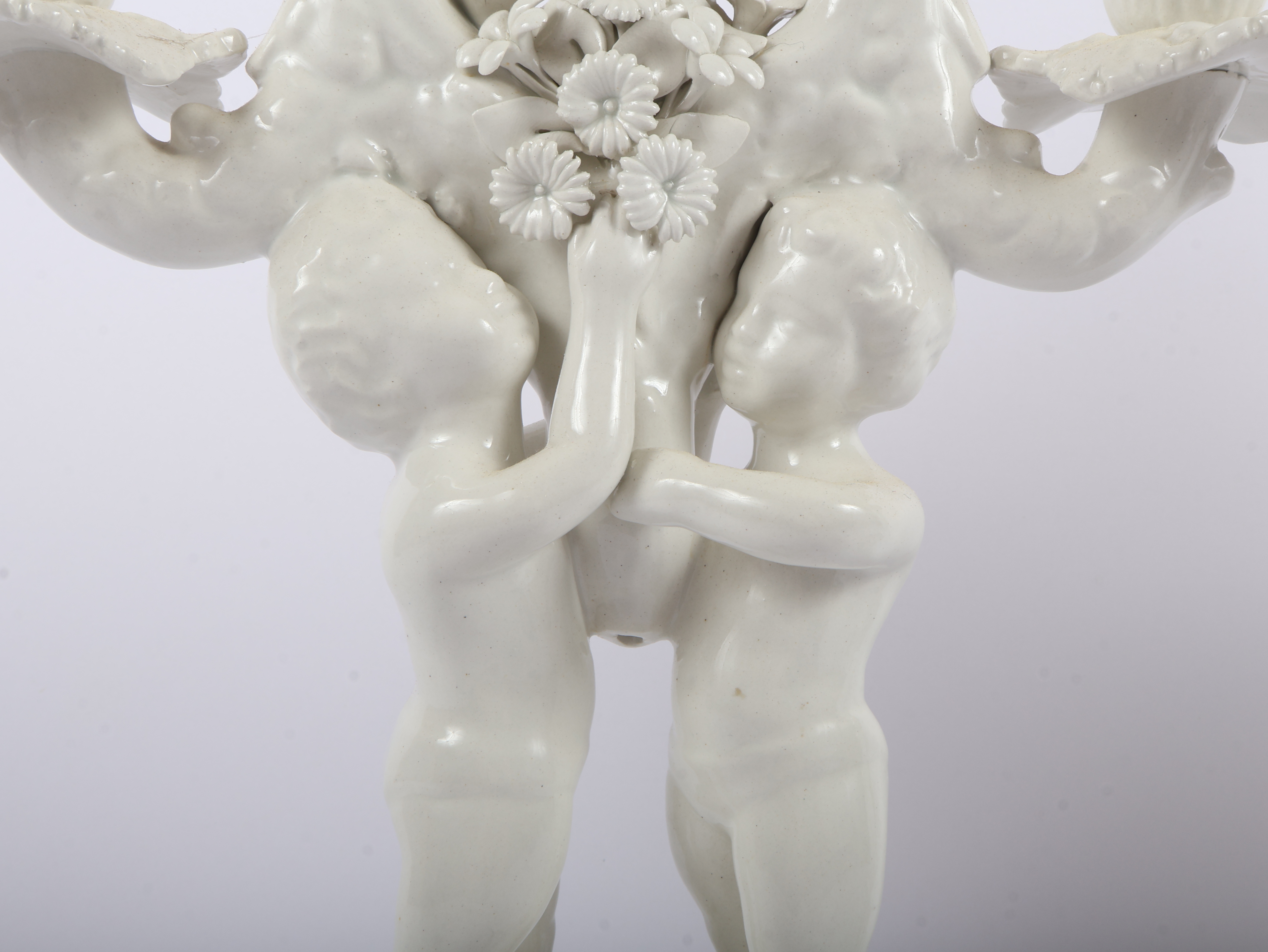 A Pair of Italian White Glazed Porcelain Three-Light Figural Candelabra