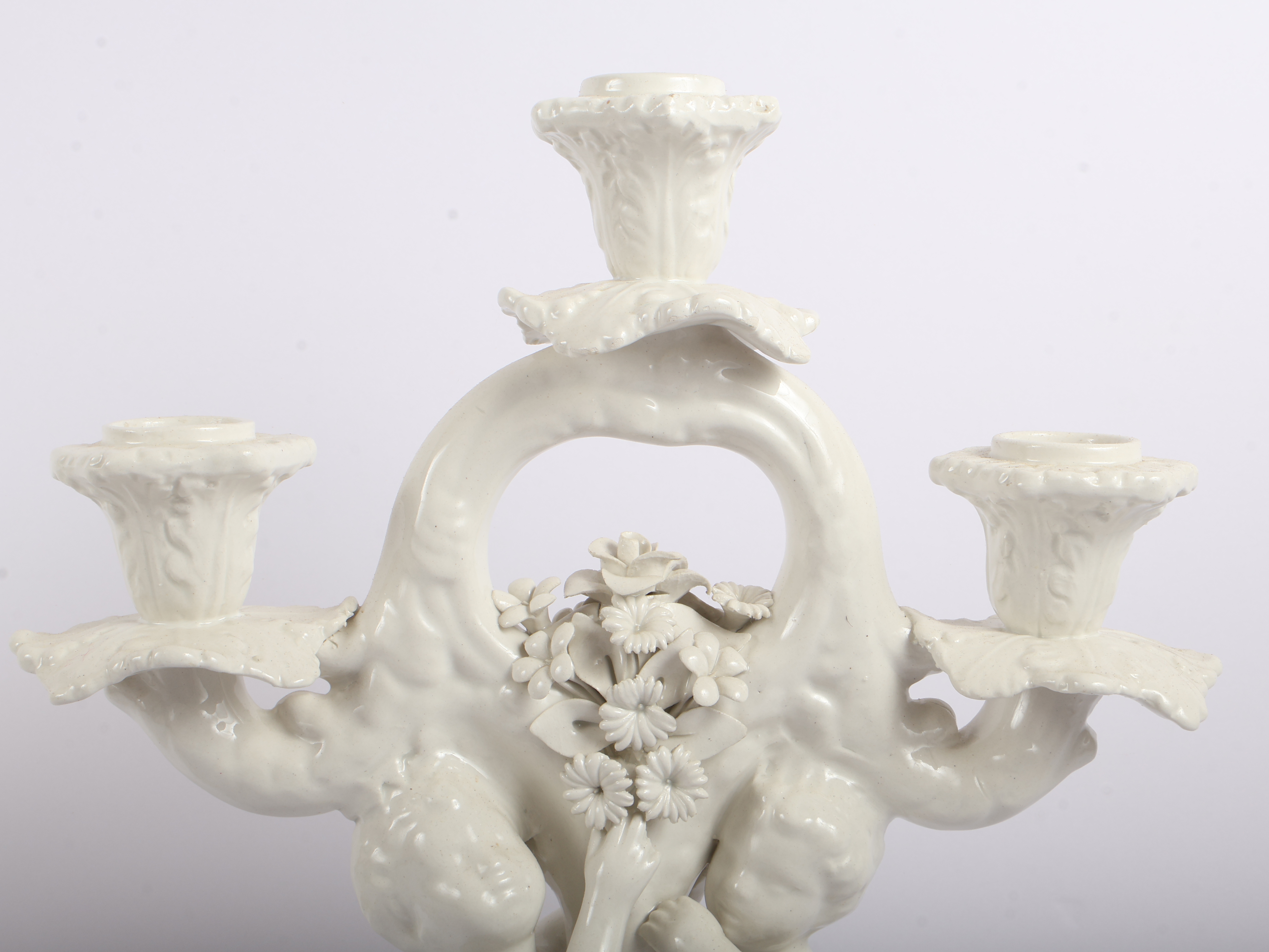 A Pair of Italian White Glazed Porcelain Three-Light Figural Candelabra