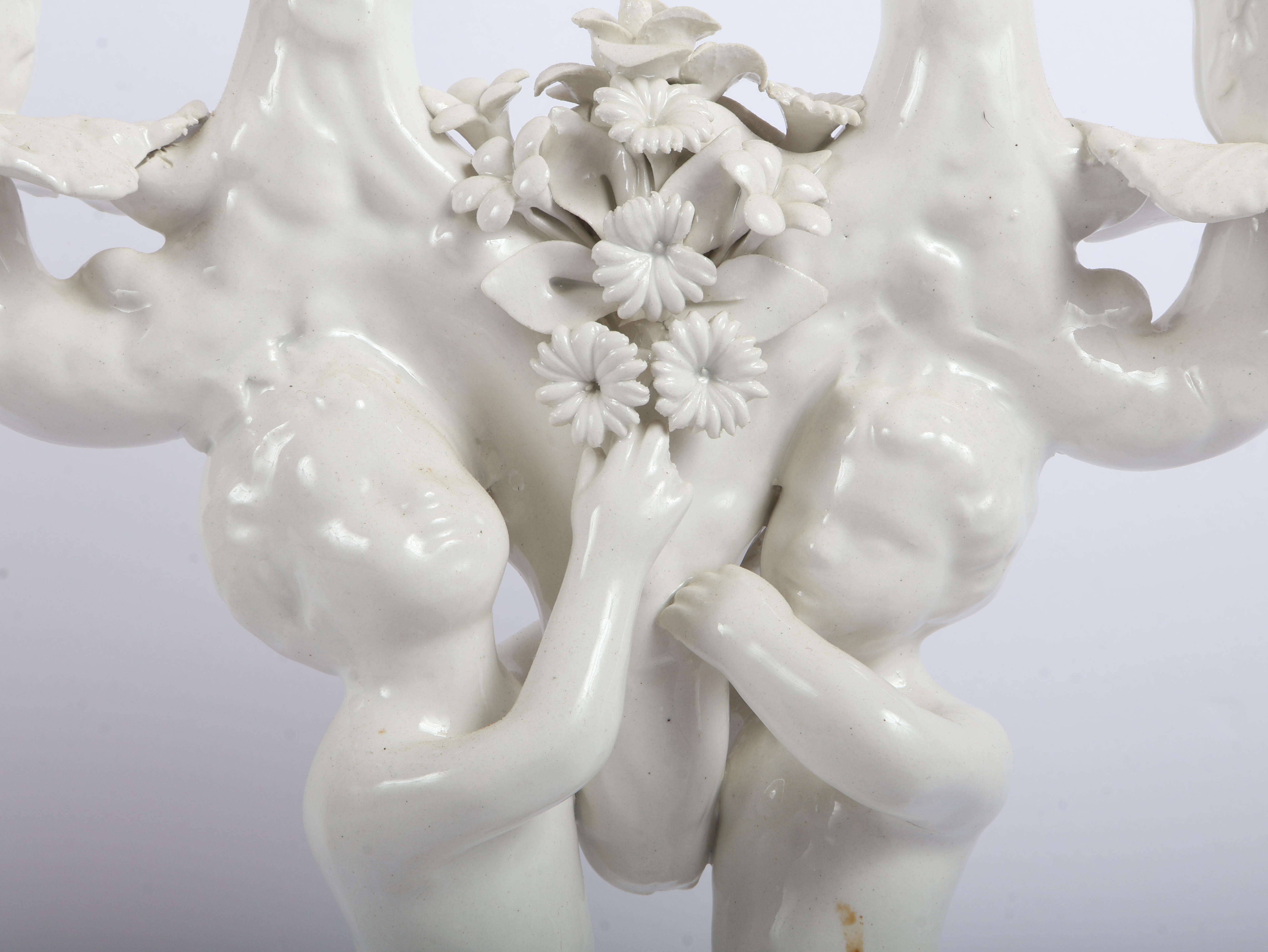 A Pair of Italian White Glazed Porcelain Three-Light Figural Candelabra