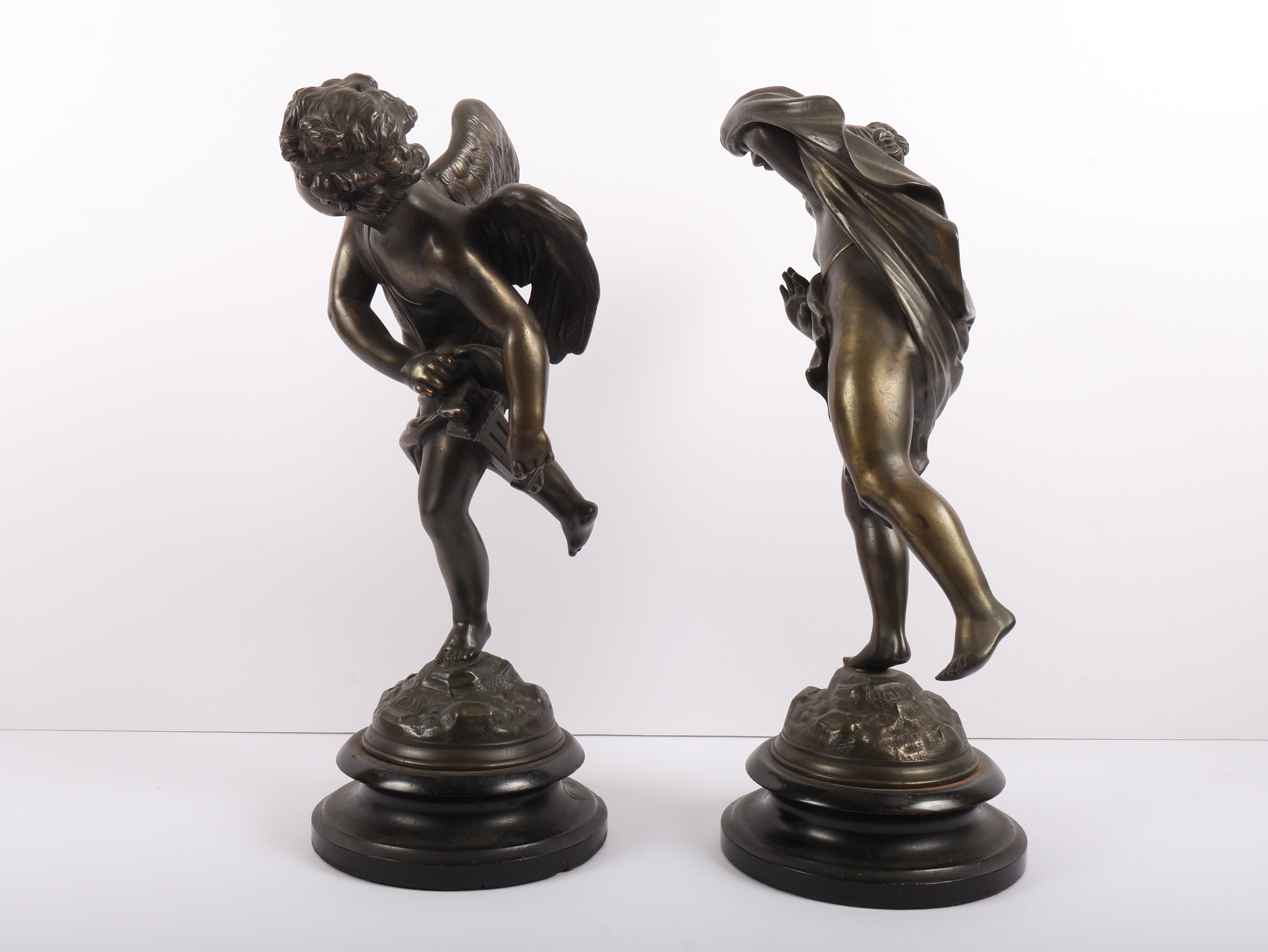 A Pair of Neoclassical Style Patinated Metal Figures of Cherubs on Ebonized Plinths