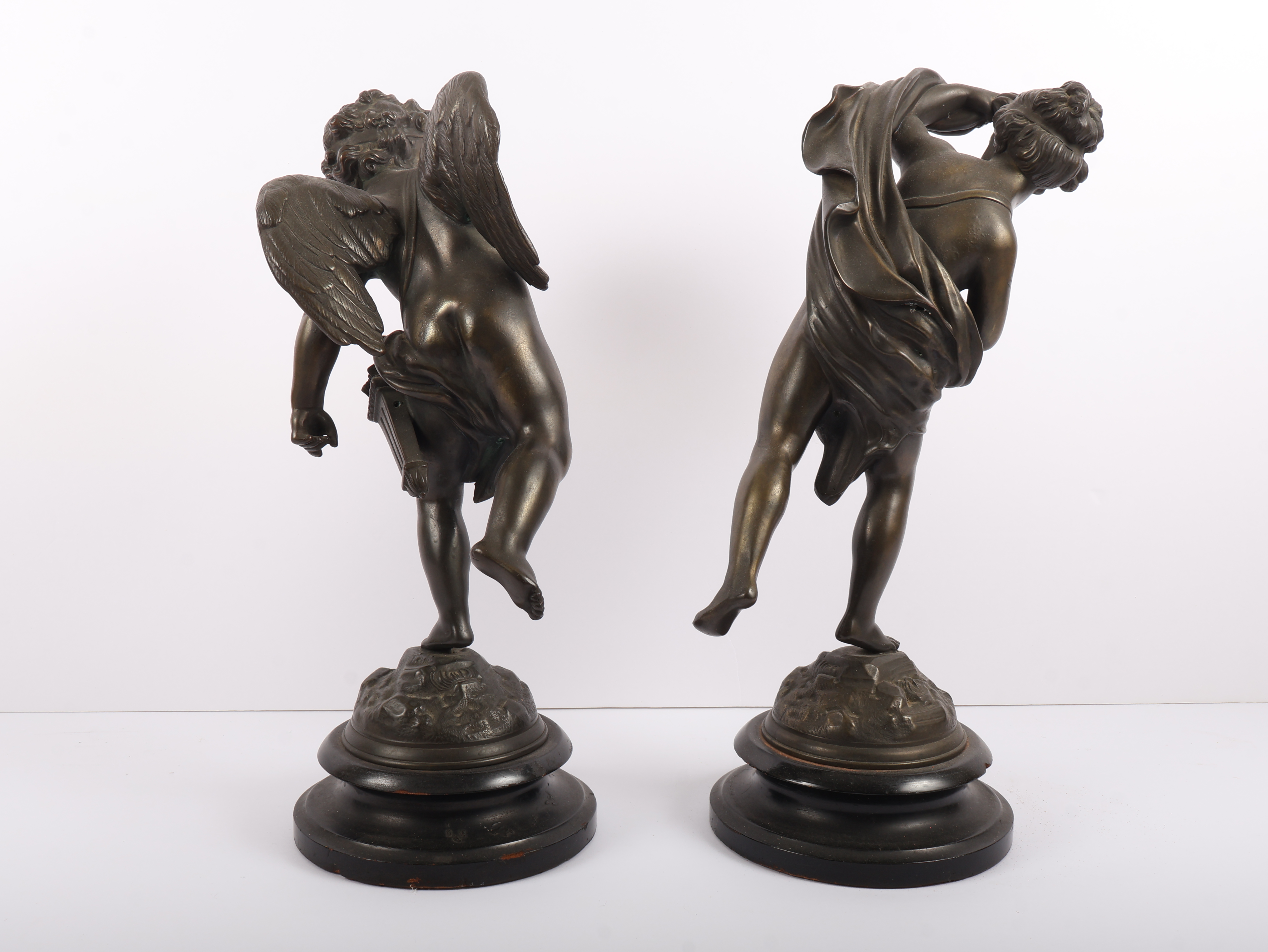 A Pair of Neoclassical Style Patinated Metal Figures of Cherubs on Ebonized Plinths