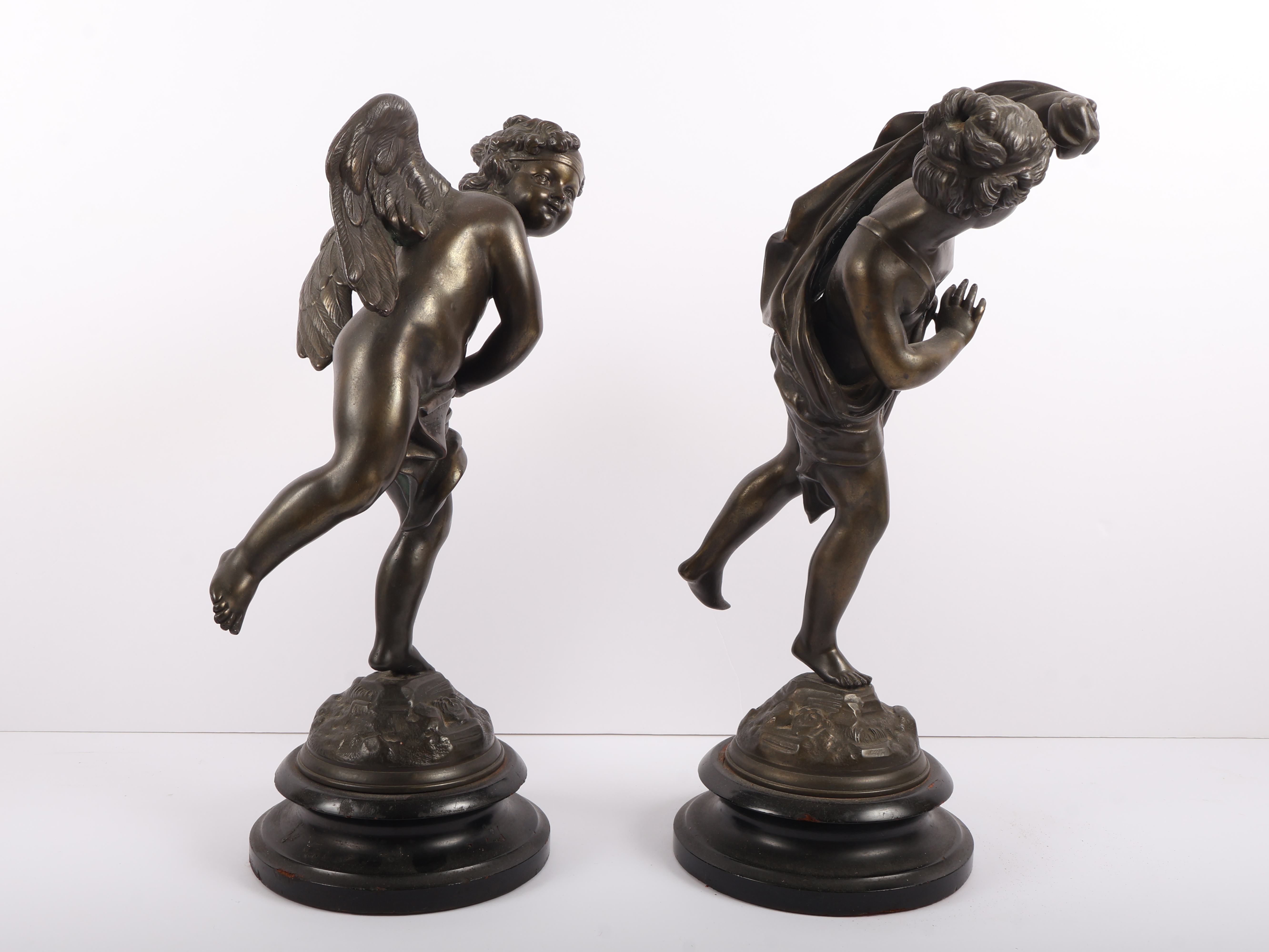 A Pair of Neoclassical Style Patinated Metal Figures of Cherubs on Ebonized Plinths