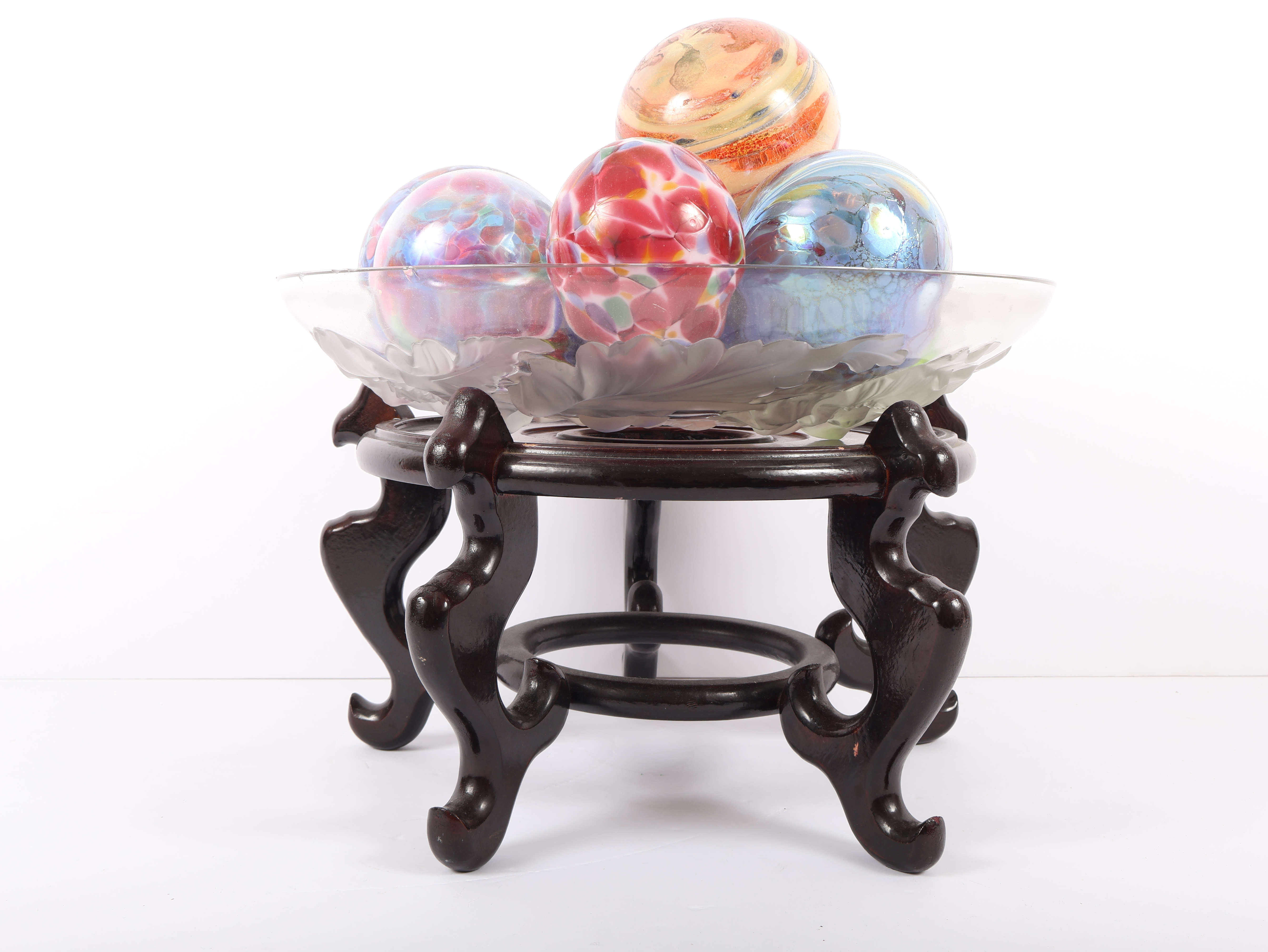 An Assortment of Eleven Blown Art Glass Spheres in a Frosted Glass Bowl on an Oriental Rosewood Stand