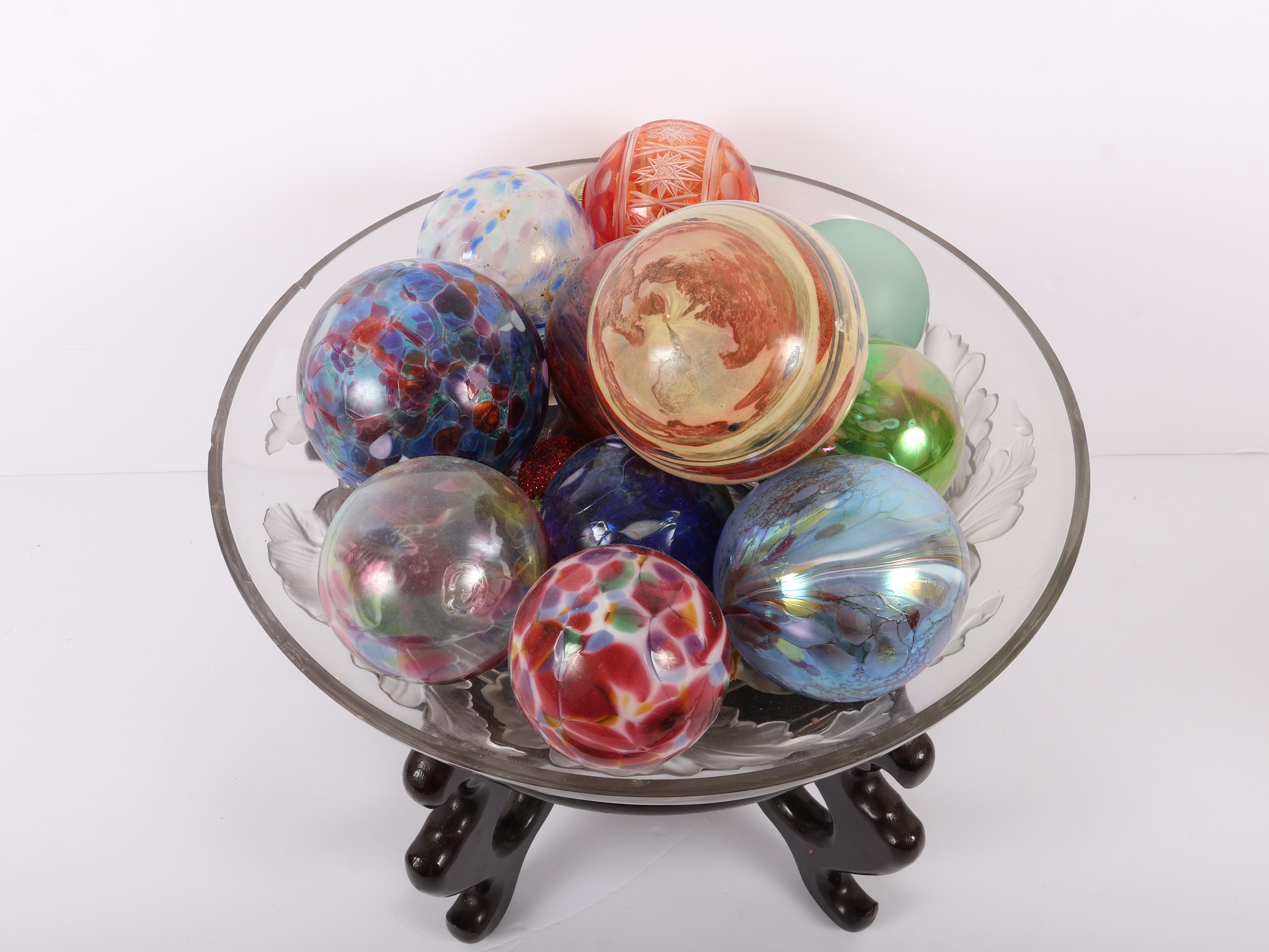 An Assortment of Eleven Blown Art Glass Spheres in a Frosted Glass Bowl on an Oriental Rosewood Stand
