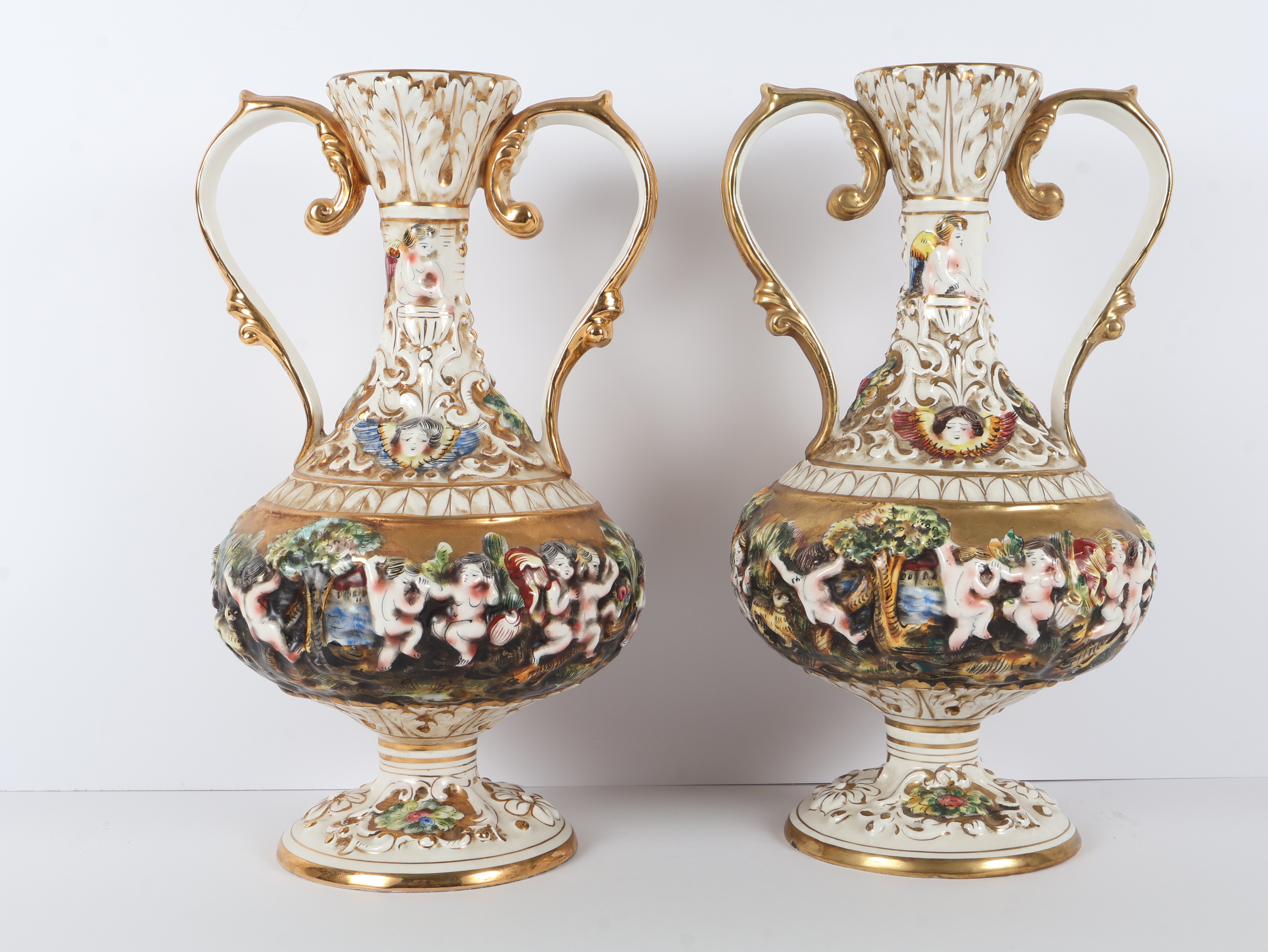 A Pair of Capodimonte Polychrome and Gilded Two-Handle Porcelain Vases
