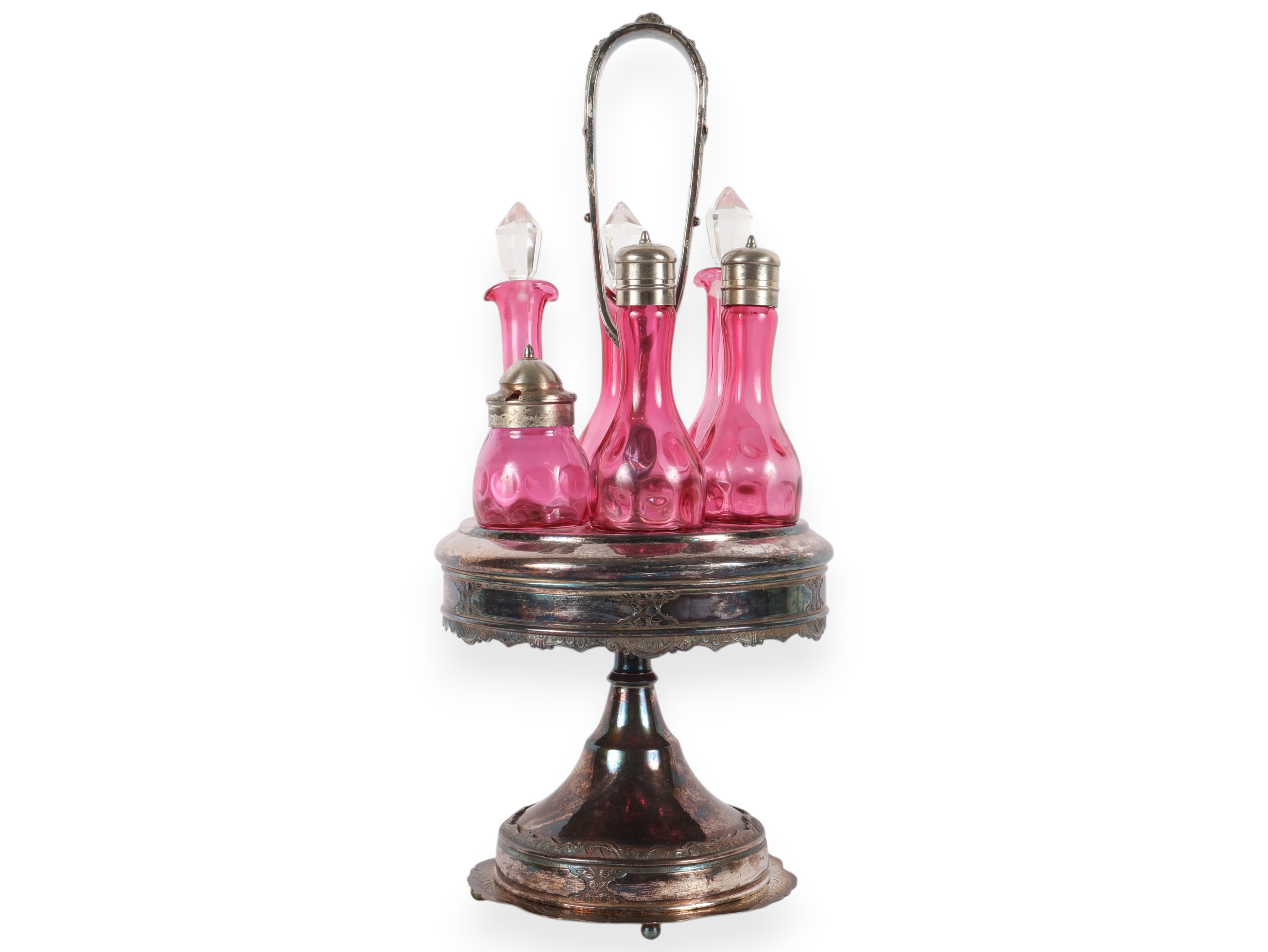 A Set of Five Victorian Cranberry Glass Bottles in an Ornate Silver-Plated Caster Stand