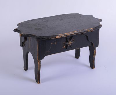 19th Century Folk Art Stool in Black Paint. Height 9 inches, width 16 inches, depth 10 inches.