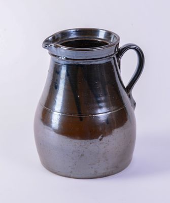 Early Redware Pitcher. Height 9.5 inches, hairline cracks at base.
