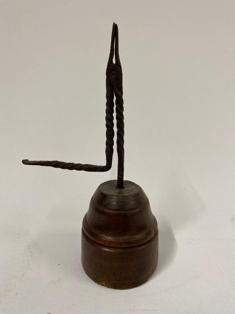 An 18th century Rush light holder on a turned wooden base