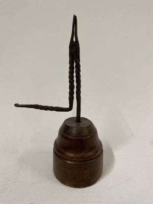 An 18th century Rush light holder on a turned wooden base