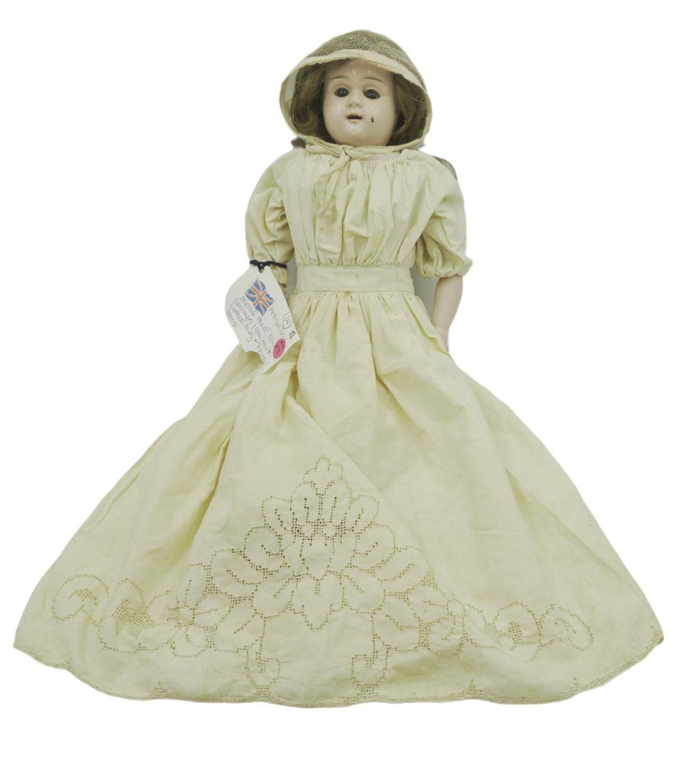 Lot 275: ANTIQUE METAL HEAD DOLL GLASS EYES