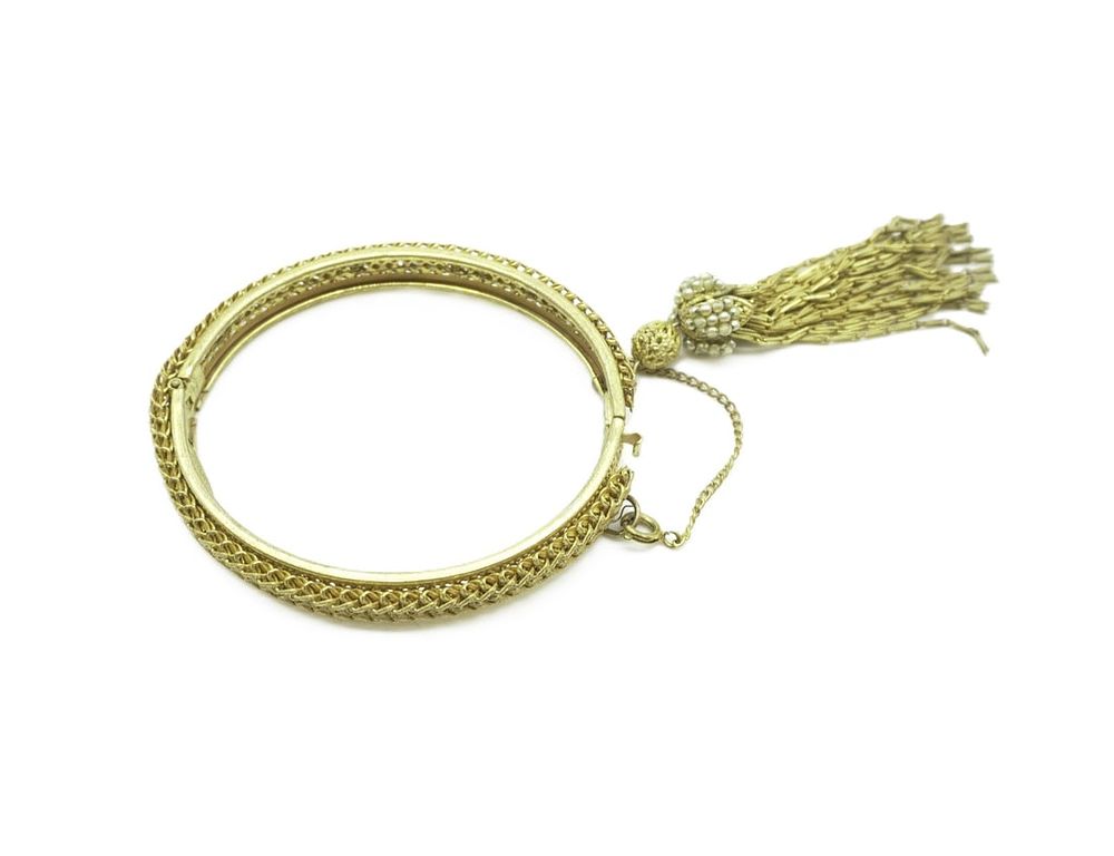Lot 53: VINTAGE MIRIAM HASKELL HINGED BANGLE BRACELET TASSEL