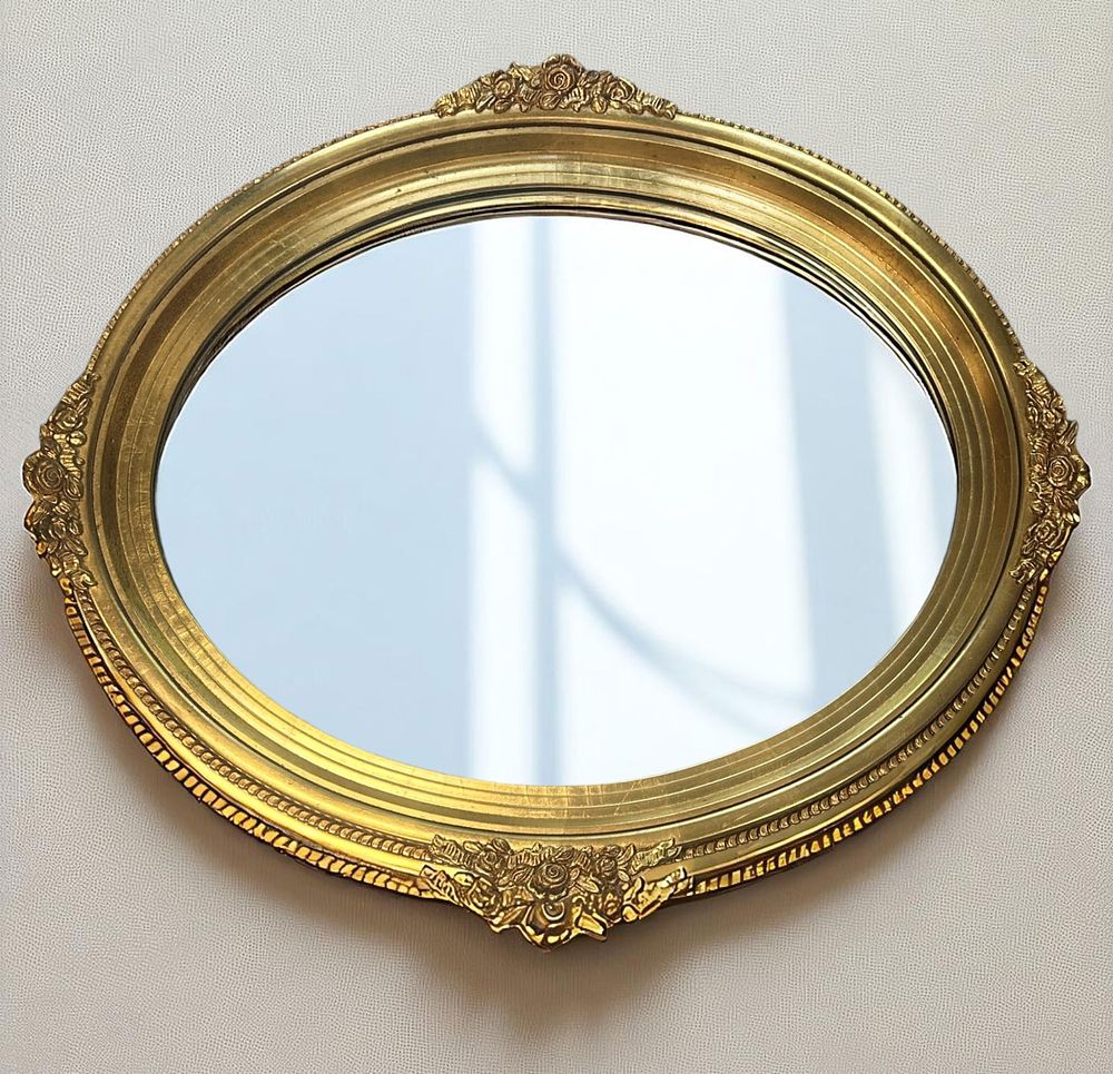 Lot 162: VINTAGE GILT OVAL MIRROR FLORAL SWAGS