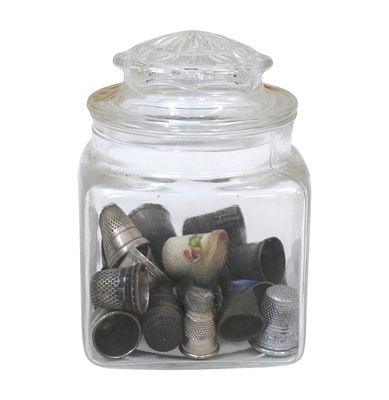 26 ANTIQUE / VINTAGE THIMBLES. 26 Antique ./ Vintage Thimbles, a few marked sterling. In a Glass 