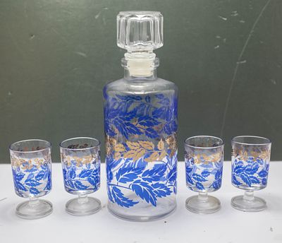 סט משקאות דקורטיבי, המורכב מקרף (בקבוק הגשה) תואם בעל פקק זכוכית, וארבע כוסות קטנות על רגל