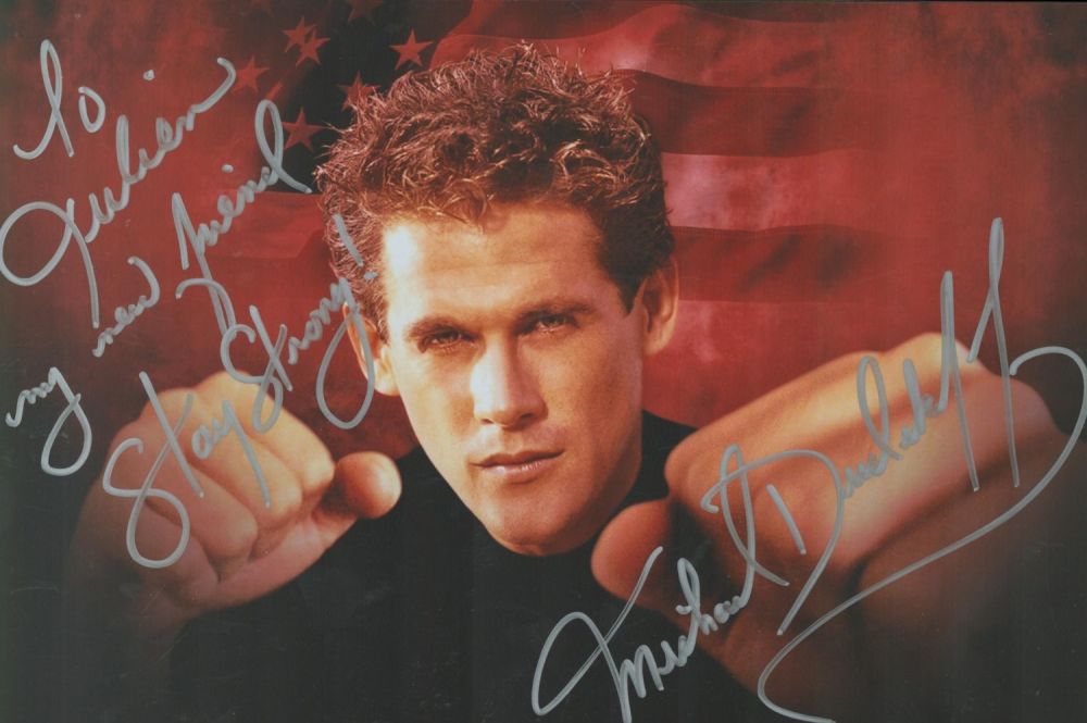 Lot 486: Michael Dudikoff signed colour photo 11.5x8 Inch. Dedicated....