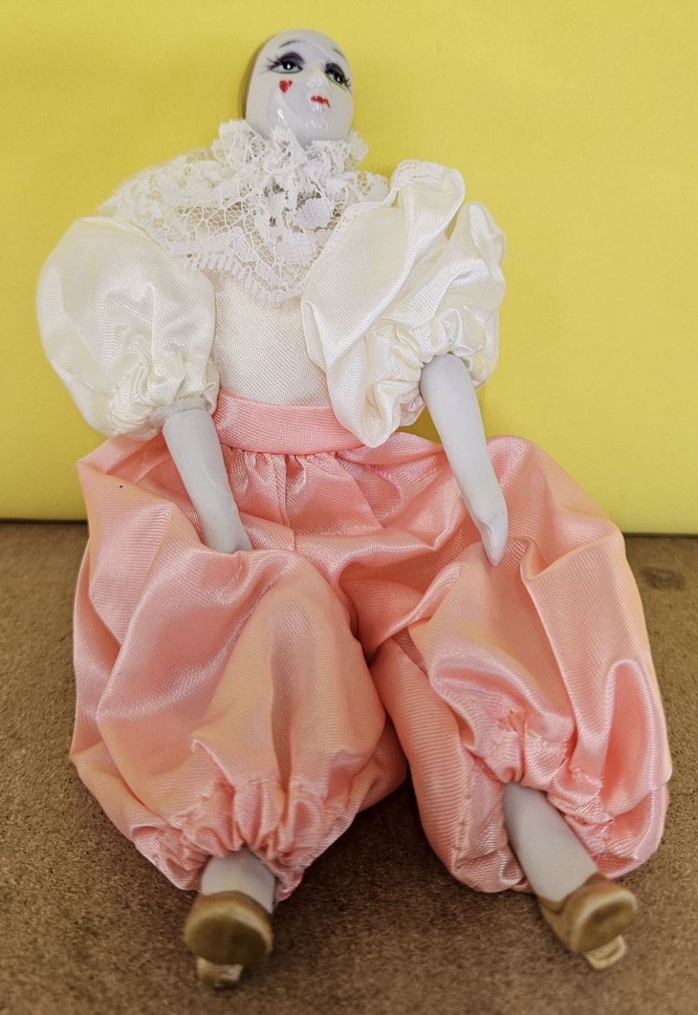 Lot 231: Vintage small Porcelain clown doll in cream lace...