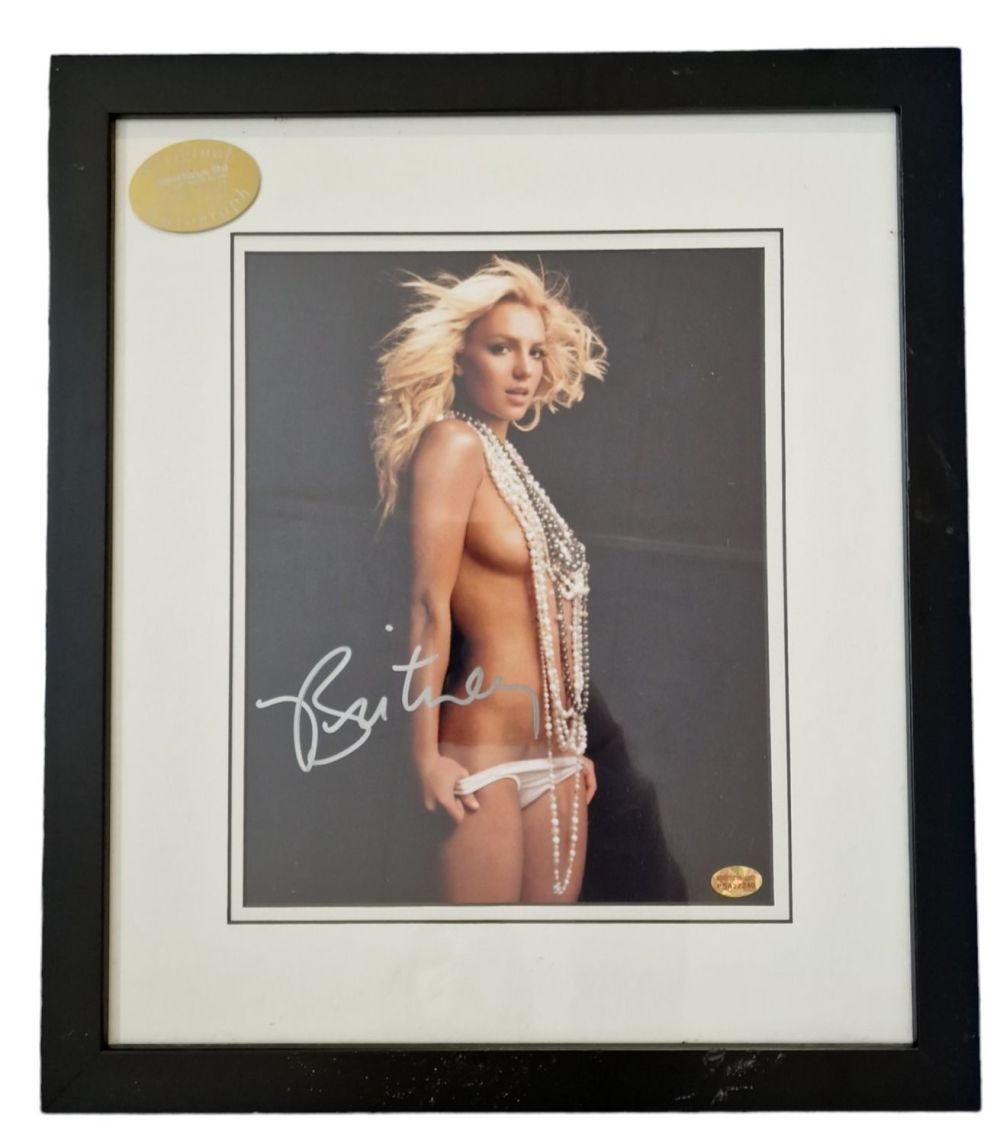 Lot 195: Britney Spears signed colour photo. Mounted and framed...